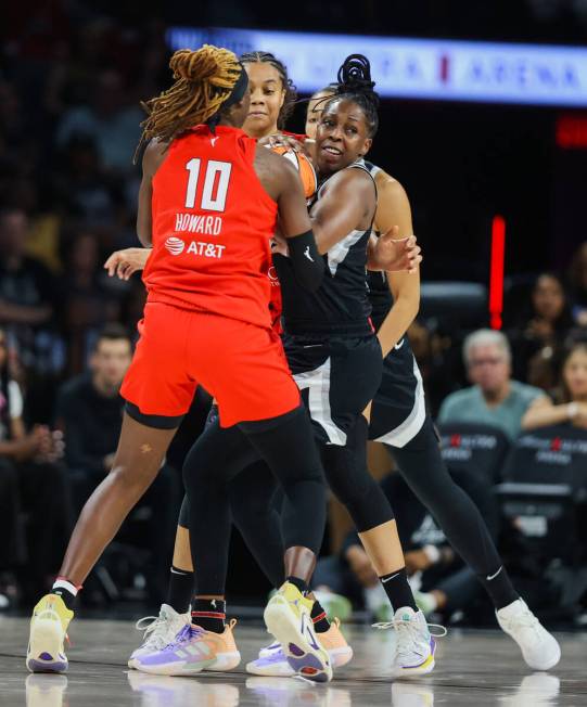 Aces guard Chelsea Gray (12) gets caught up in Atlanta Dream defense during a WNBA basketball g ...