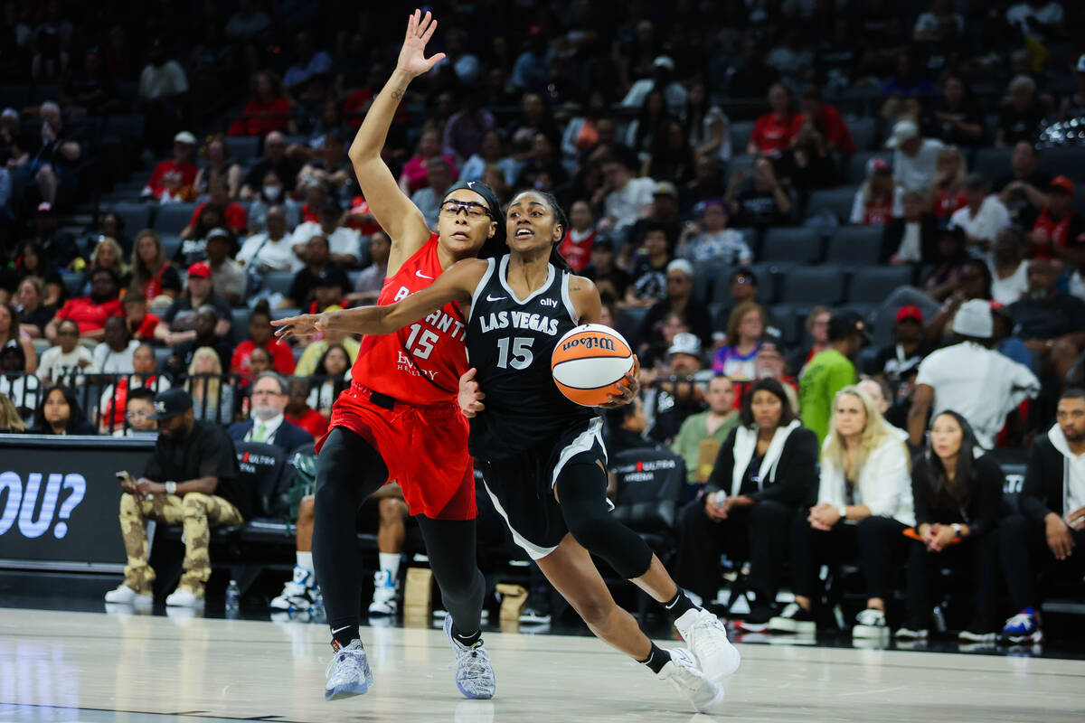 Aces guard Tiffany Hayes, right, drives the ball to the basket as Atlanta Dream guard Allisha G ...