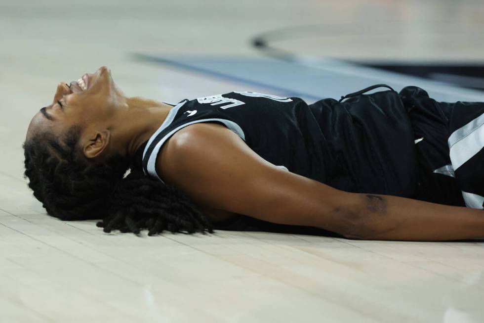 Aces guard Tiffany Hayes (15) lays on the floor after falling during a WNBA basketball game bet ...