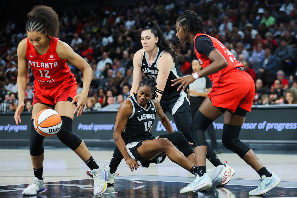 Aces guard Tiffany Hayes (15) falls to the floor as she loses her grip on the ball during a WNB ...