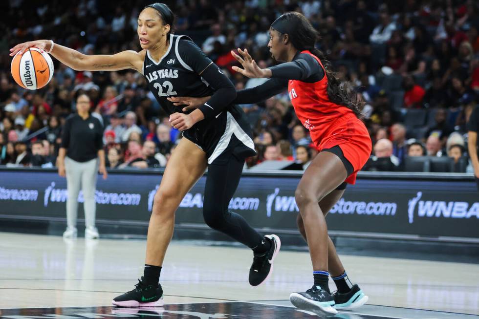 Aces center A'ja Wilson (22) brings the ball closer to her during a WNBA basketball game betwee ...