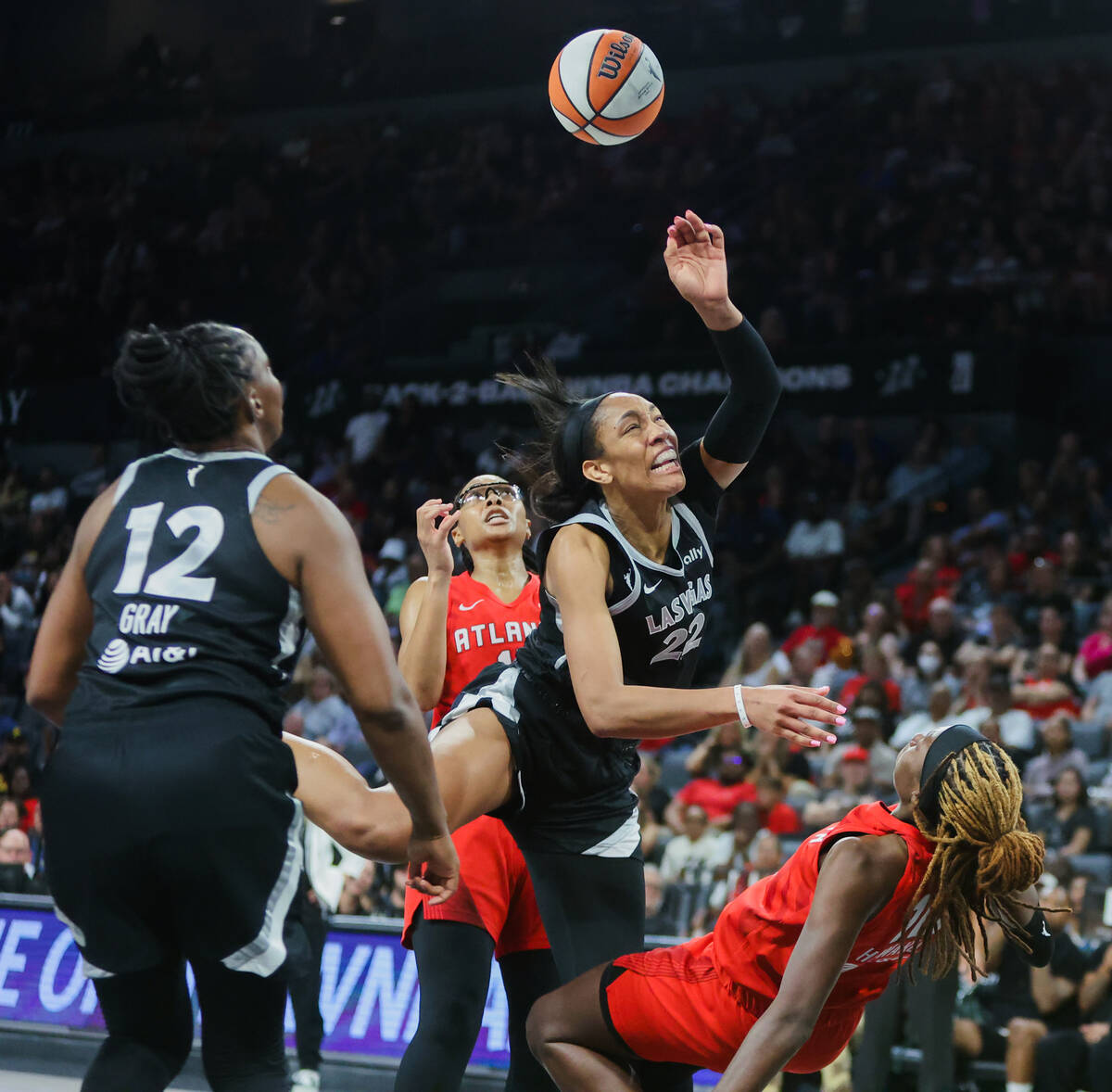 Aces center A'ja Wilson (22) is fouled by Atlanta Dream guard Rhyne Howard (10) during a WNBA b ...