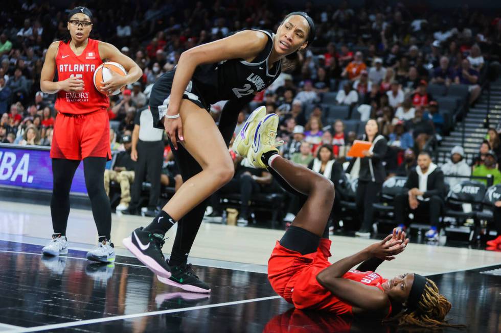 Aces center A'ja Wilson (22) is fouled by Atlanta Dream guard Rhyne Howard (10) during a WNBA b ...