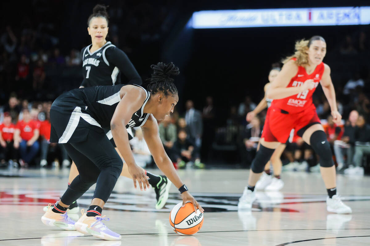 Aces guard Chelsea Gray (12) picks up the ball after it became loose during a WNBA basketball g ...