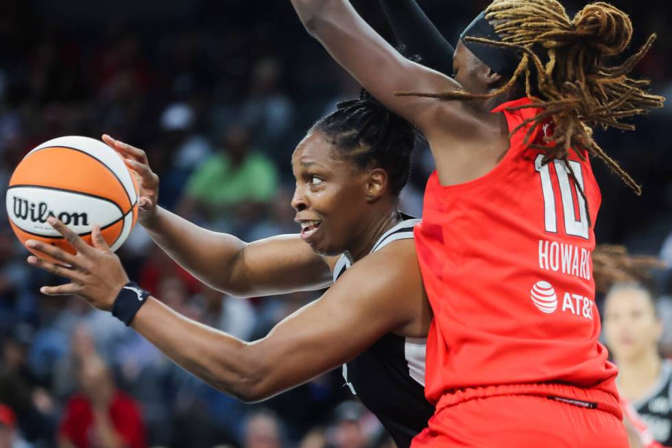 Aces guard Chelsea Gray (12) hands the ball off to a teammate during a WNBA basketball game bet ...