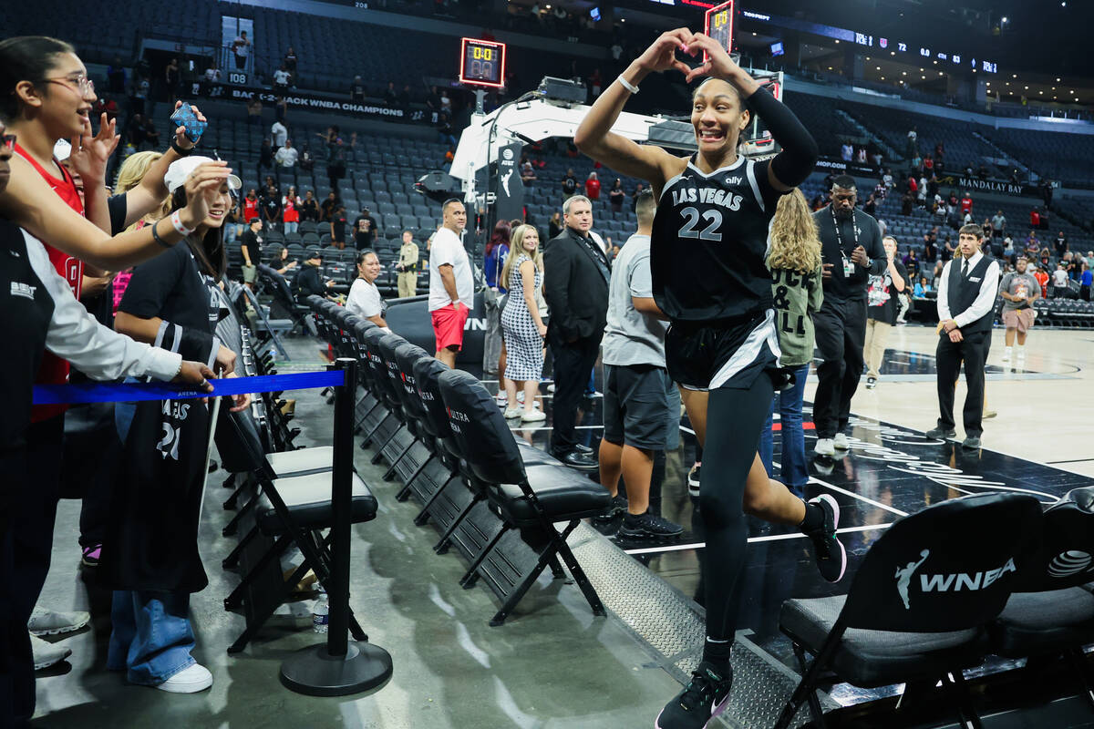 Aces center A'ja Wilson gives heart hands to fans as she exits the court following a WNBA baske ...