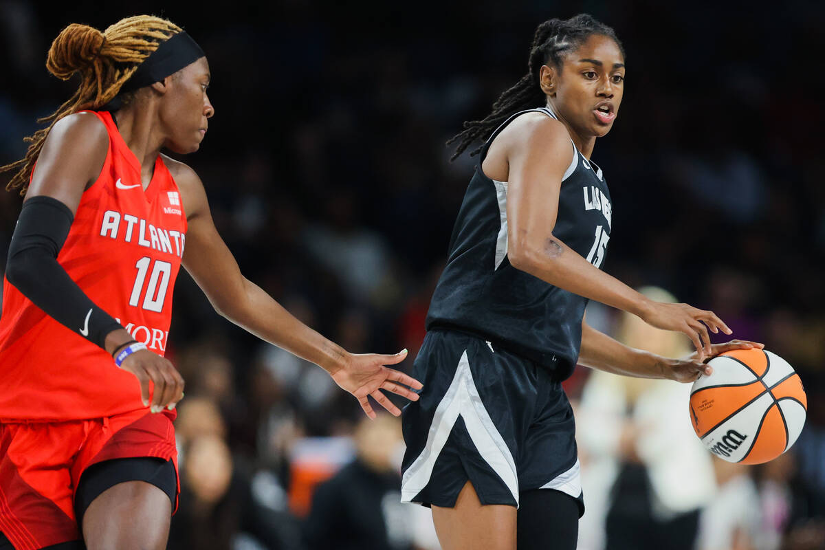 Aces guard Tiffany Hayes (15) dribbles the ball as Atlanta Dream guard Rhyne Howard (10) plays ...