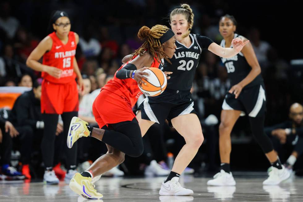 Atlanta Dream guard Rhyne Howard (10) runs the ball across the. Court as Aces guard Kate Martin ...