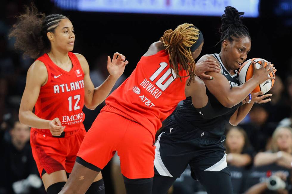 Aces guard Chelsea Gray (12) moves the ball out from Atlanta Dream defense during a WNBA basket ...