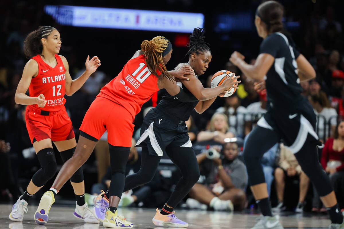 Aces guard Chelsea Gray (12) moves the ball out from Atlanta Dream defense during a WNBA basket ...