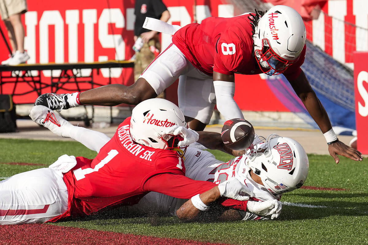 Houston defensive backs Latrell McCutchin Sr. (1) and Kentrell Webb (8) break up a pass intende ...