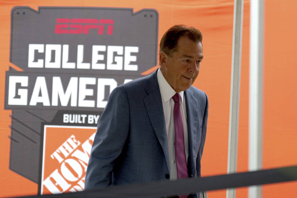 ESPN football analyst Nick Saban walks to the stage of College Game Day outside of Kyle Field o ...