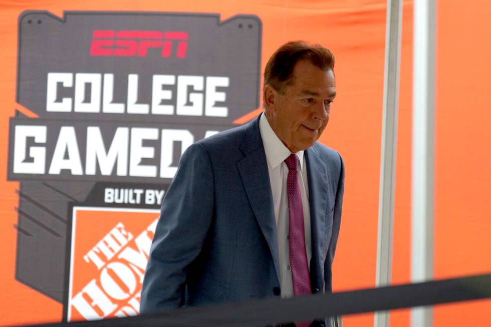 ESPN football analyst Nick Saban walks to the stage of College Game Day outside of Kyle Field o ...