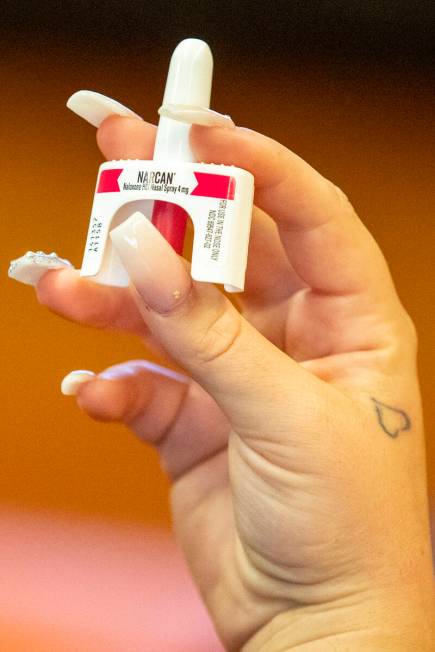 Packages of Naloxone HCI Nasal Spray are passed around as attendees are trained on how to admin ...