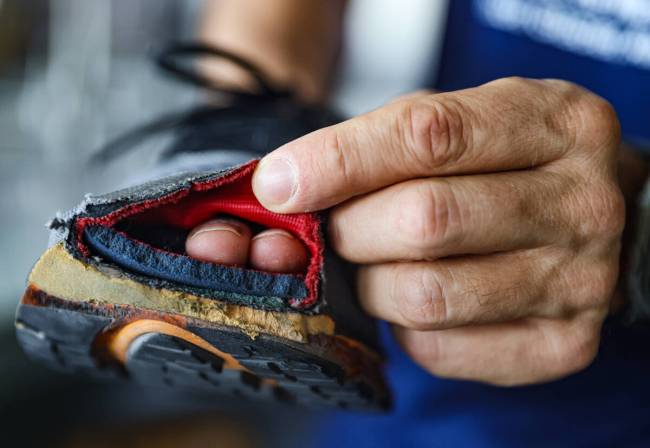 Derek Stefureac shows a running shoe with a hole in the toe from running with multiple sclerosi ...