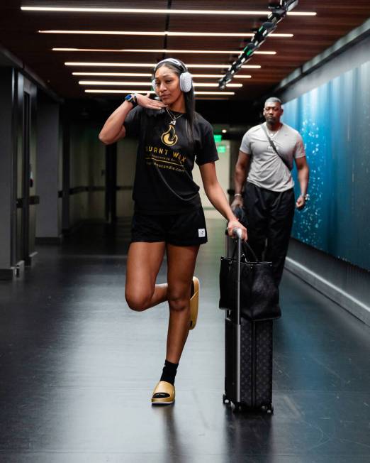 Aces star A'ja Wilson poses wearing a shirt that reps her and her mother's candle line, Burnt W ...