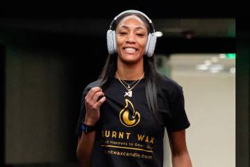 Aces star A'ja Wilson poses wearing a shirt that reps her and her mother's candle line, Burnt W ...