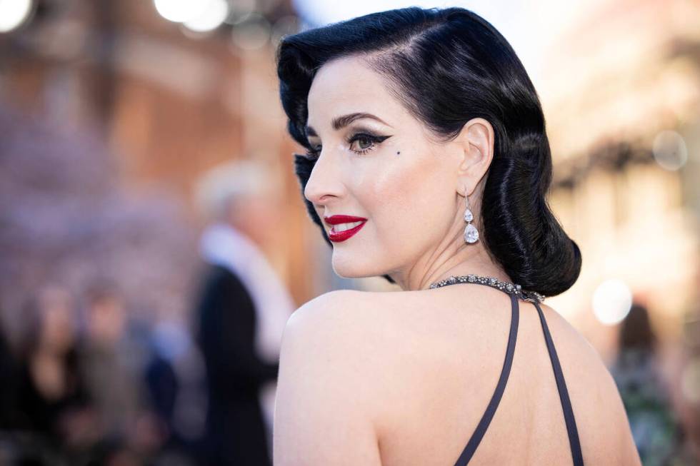 Dita Von Teese poses for photographers upon arrival at the Olivier Awards in London, Sunday, Ap ...