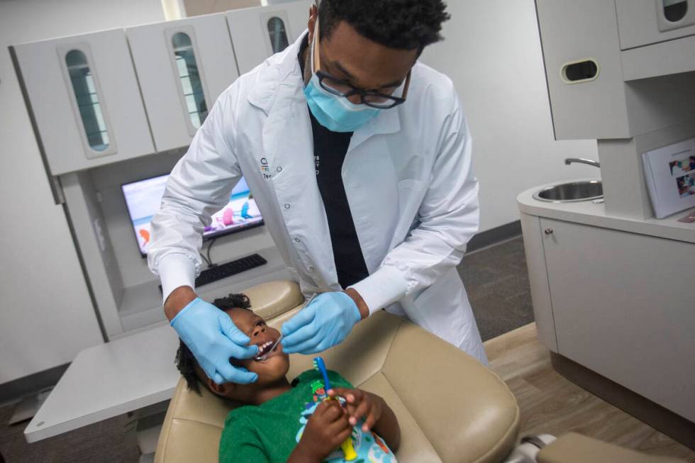 Dentist Terry Meads looks at the teeth of Sammy Hale, 4, at Changing Smiles Pediatric Dentistry ...