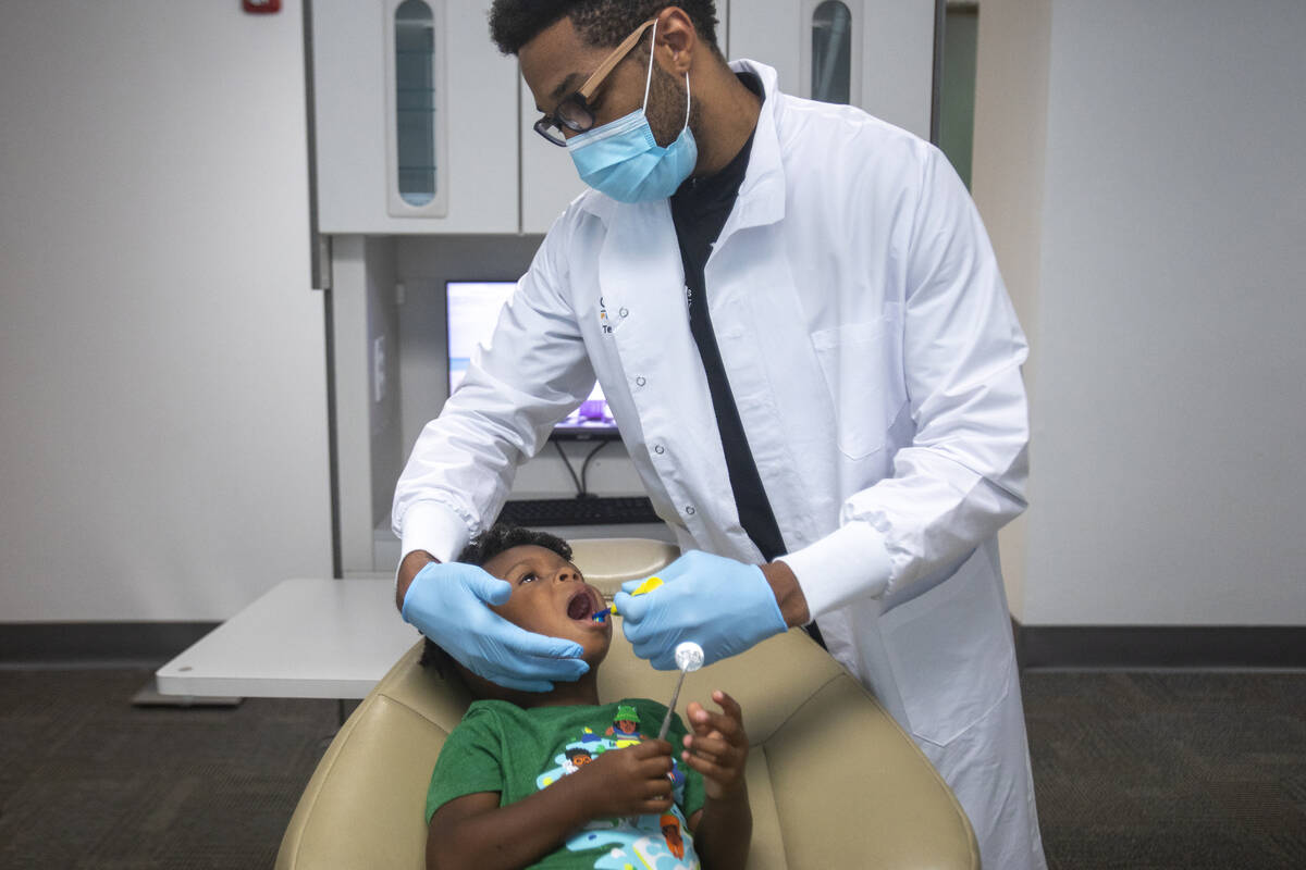 Sammy Hale, 4, has his teeth cleaned by dentist Terry Meads at Changing Smiles Pediatric Dentis ...