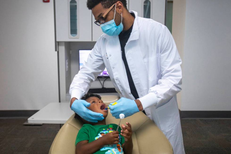 Sammy Hale, 4, has his teeth cleaned by dentist Terry Meads at Changing Smiles Pediatric Dentis ...