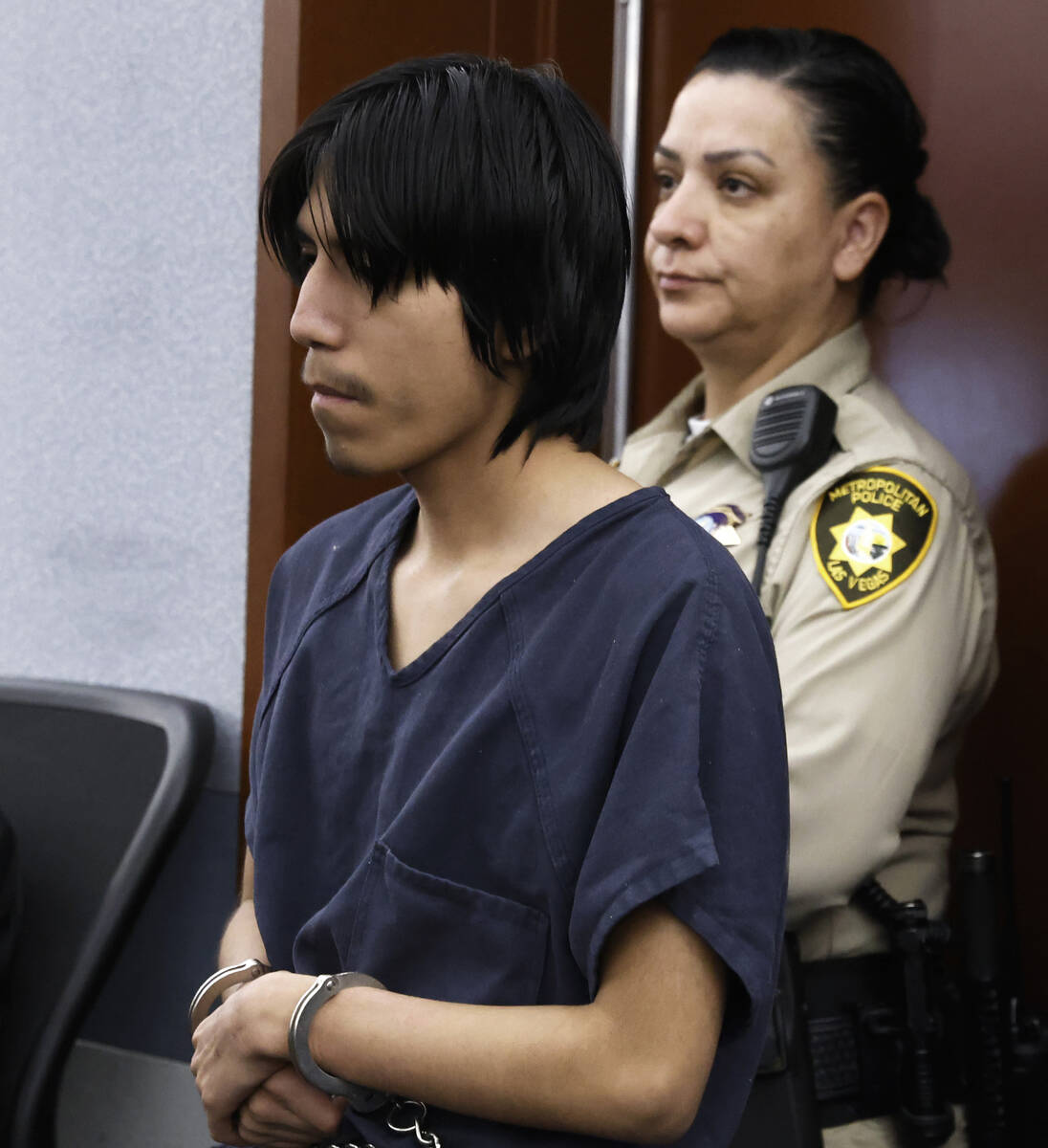 Joshua Robles, center, who is facing terrorism-related charges, led into a courtroom during a h ...