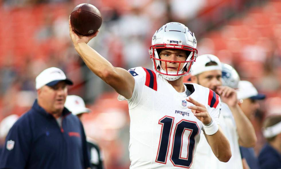 New England Patriots quarterback Drake Maye (10) throws before an NFL football game against the ...