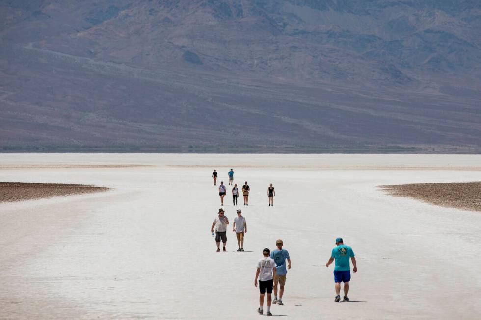 Tourists visit the Badwater Basin Monday, July 8, 2024, in Death Valley National Park, Californ ...