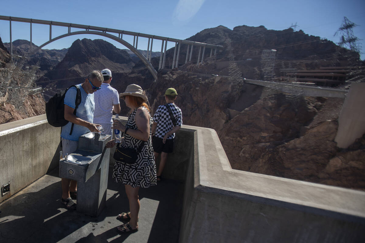 Tourists fill their water containers at the Hoover Dam Friday, July 5, 2024, in Boulder City. ( ...