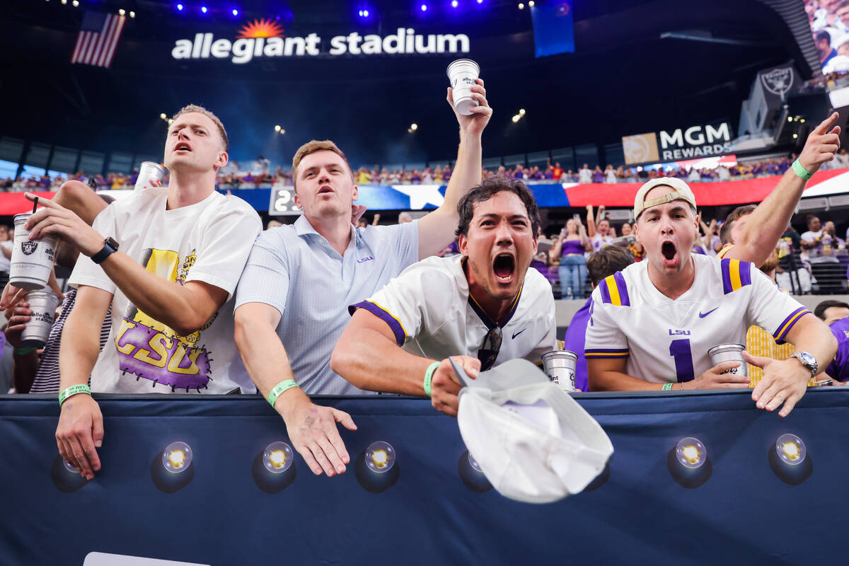 LSU fans cheer as their team takes the field during the Vegas Kickoff Classic NCAA football gam ...