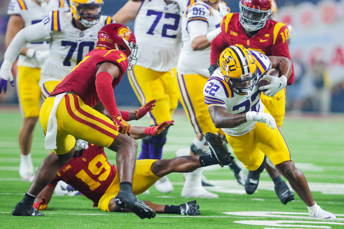 LSU running back John Emery Jr. (22) breaks out of Southern California defense to carry the bal ...