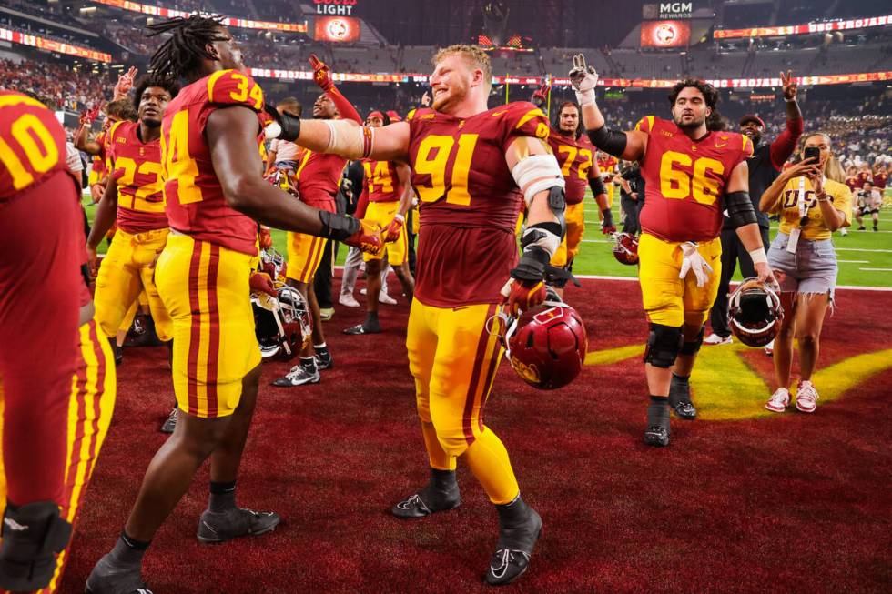 Southern California players celebrate winning the Vegas Kickoff Classic NCAA football game betw ...