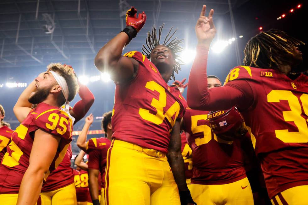 Southern California players celebrate winning the Vegas Kickoff Classic NCAA football game betw ...