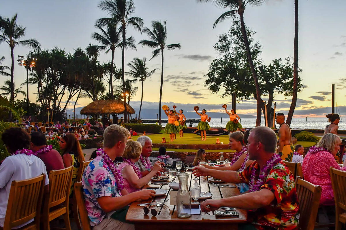 A luau on the waterfront of West Maui features dinner and an hourlong performance, including hu ...