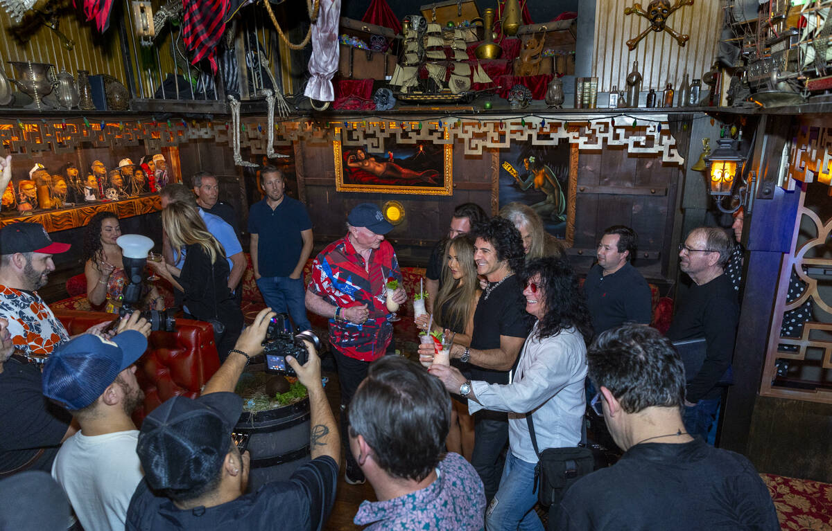 Beach Boys legend Mike Love, center, shares a drink with friends before receiving a shrunken he ...