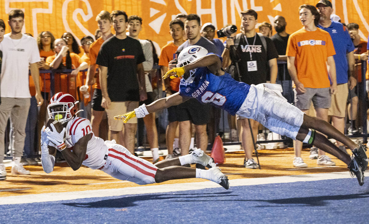 Mater Dei's wide receiver Marcus Harris (10) dives to catch a touchdown pass as Bishop Gorman's ...