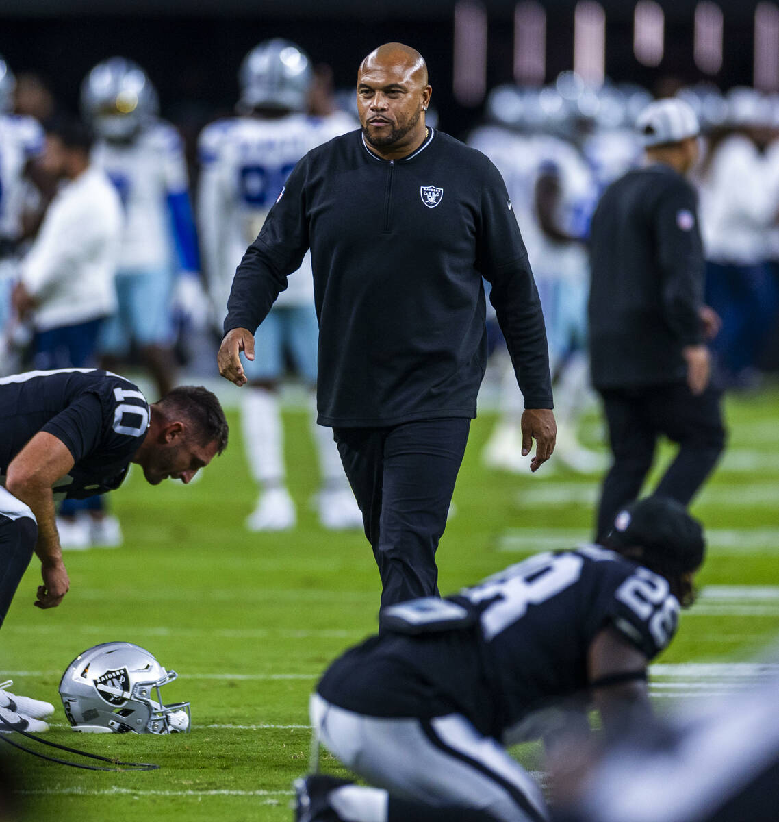 Raiders head coach Antonio Pierce walks amongst this players as they face the Dallas Cowboys fo ...