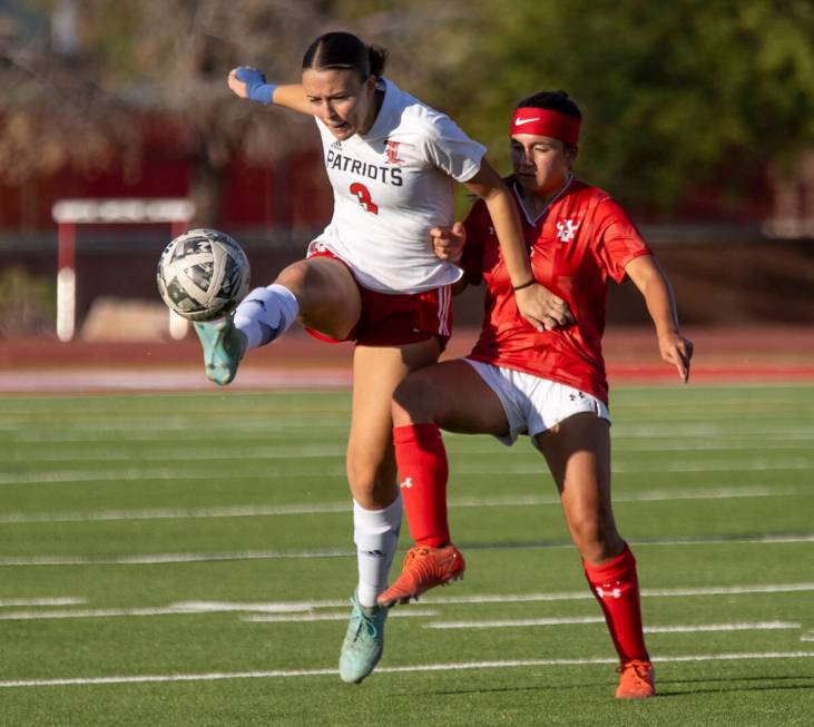 Liberty defender Rayen Garrett (3) and Arbor View sophomore Danielle Morales (3) compete for th ...