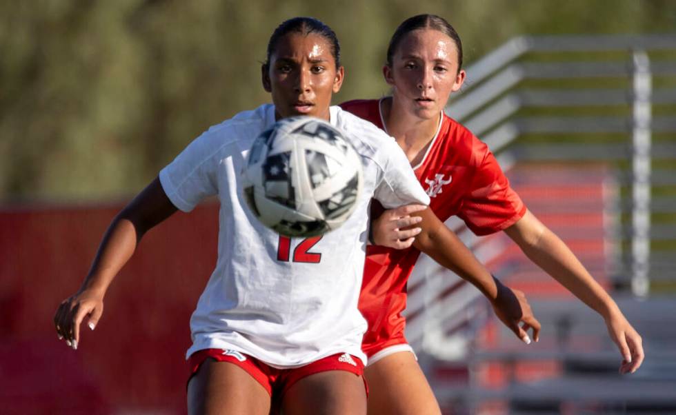 Liberty junior Ayva Jordan (12) and Arbor View sophomore Bailee Little (8) compete for the ball ...