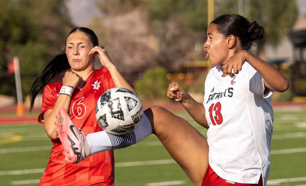 Arbor View sophomore Cadence Atkina (6) and Liberty senior Regina Cisneros (13) compete for the ...