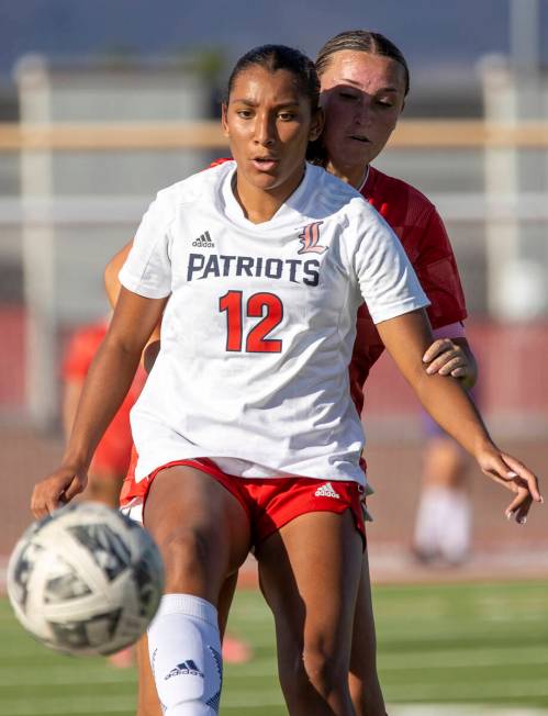 Liberty junior Ayva Jordan (12) and Arbor View senior Gabriella Aguilar (21) compete for the ba ...