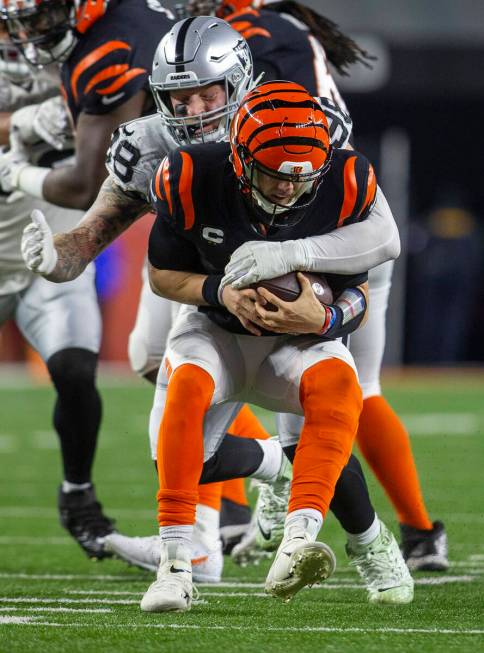 Raiders defensive end Maxx Crosby (98) sacks Cincinnati Bengals quarterback Joe Burrow (9) duri ...