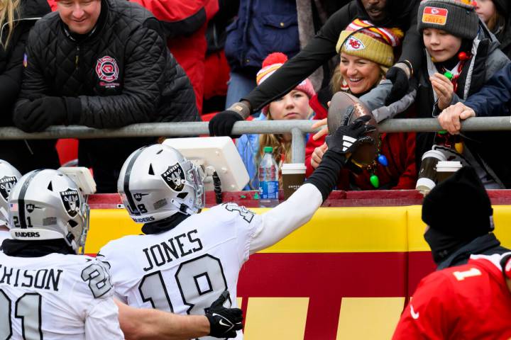 Las Vegas Raiders cornerback Jack Jones (18) gives the ball to fans after scoring a touchdown o ...