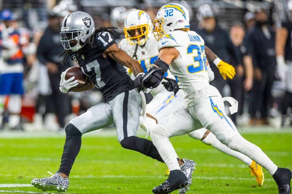 Raiders wide receiver Davante Adams (17) runs after a catch as Los Angeles Chargers safety Aloh ...