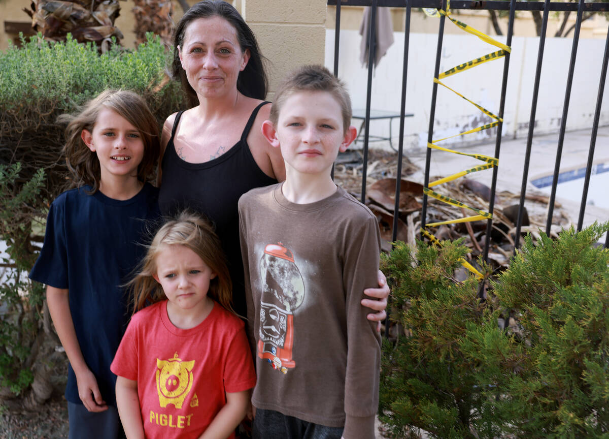 Amanda Ahlstrom, who owns a unit at Somerset Park townhouse complex in Henderson, poses with th ...