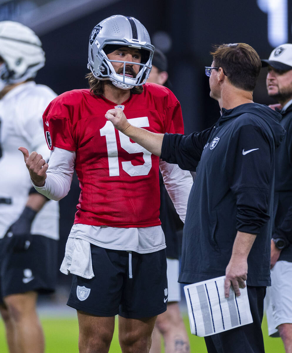 Raiders quarterback Gardner Minshew (15) talks with a coach during an open practice at Allegian ...