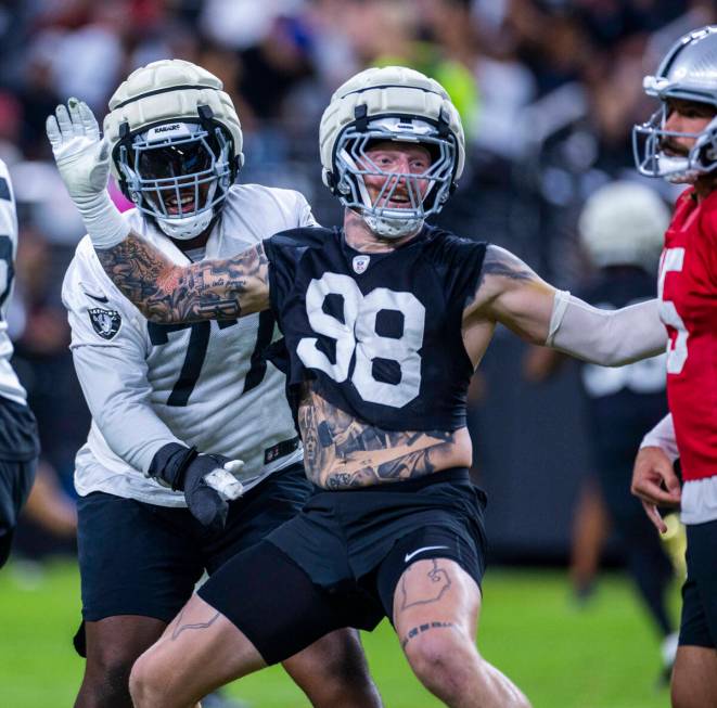 Raiders defensive end Maxx Crosby (98) gets past offensive tackle Thayer Munford Jr. (77) towar ...