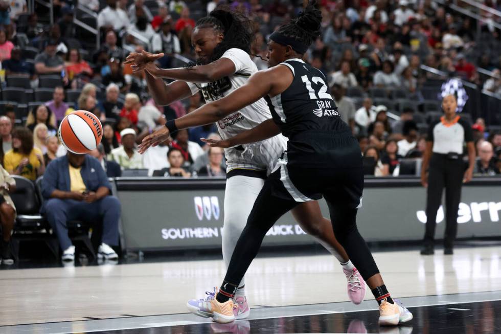 Chicago Sky forward Michaela Onyenwere (12) loses control of the ball while Las Vegas Aces guar ...