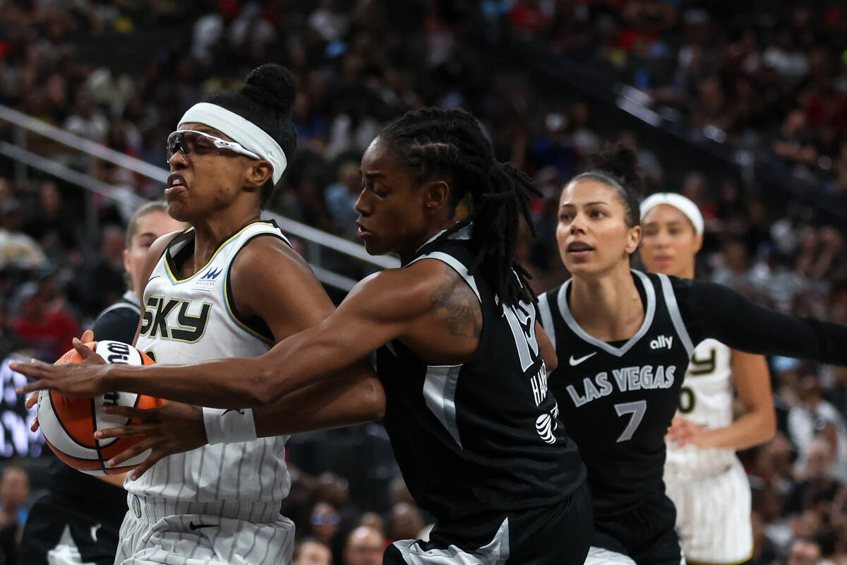 Chicago Sky guard Diamond DeShields, left, drives toward the hoop while Las Vegas Aces guard Ti ...