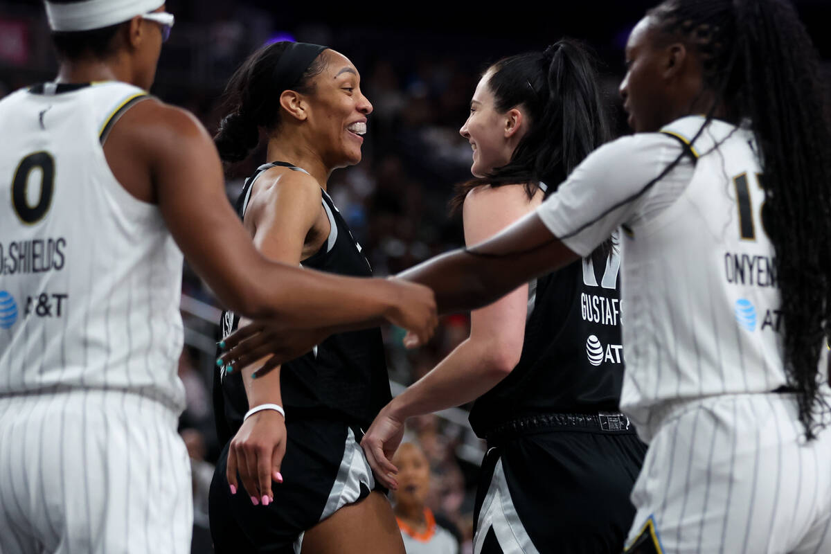 Las Vegas Aces center A'ja Wilson, center left, and center Megan Gustafson, center right, celeb ...